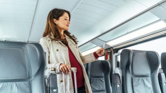 Une femme cherche sa place dans le train.