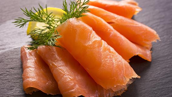 Des tranches de saumon posées sur une ardoise